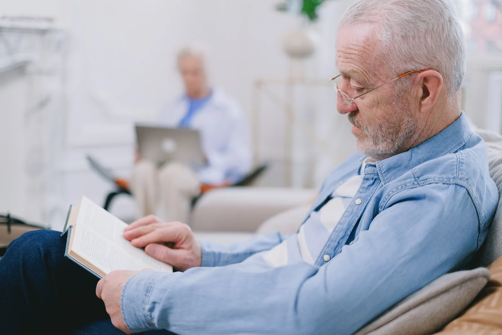 Older man reading in a quiet evening setting