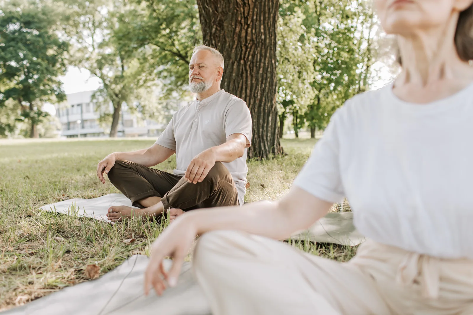 Older man practising gentle yoga and mindful breathing